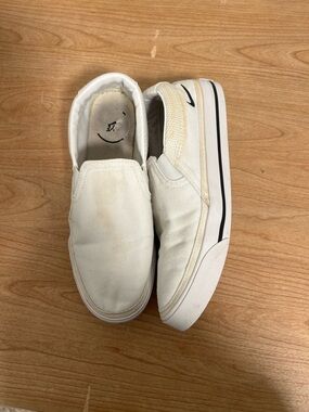 Nike White Slip-On Sneakers with Black Swoosh Detail